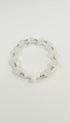 Jefgo stretch bracelet featuring clear crackle-glass beads, silver-tone spacers, and a central white cross charm.
